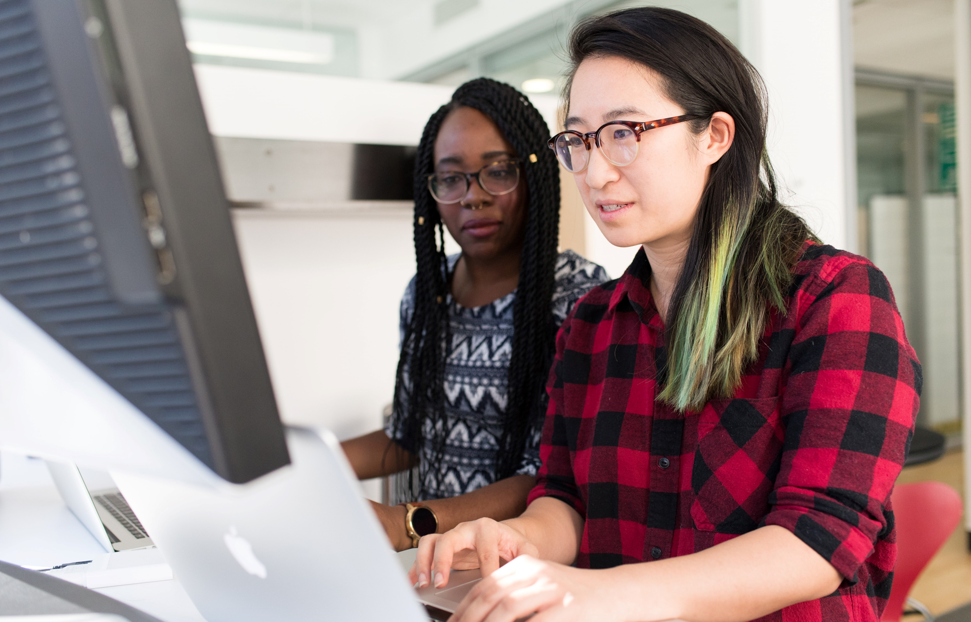 Two young women collaborating in an office setting