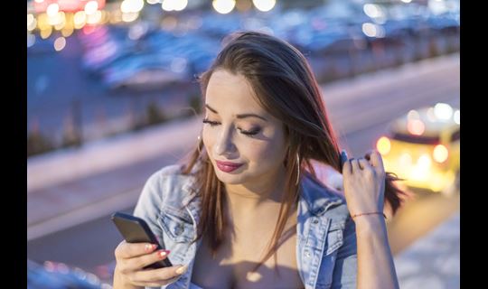 woman on smartphone in urban setting