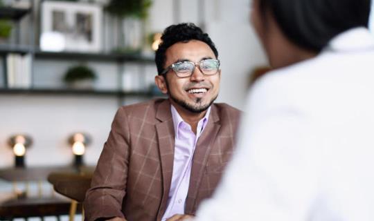 Man talking to veterinarian during a business meeting